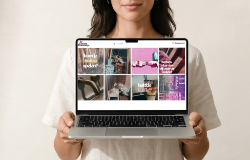 A person holding a laptop showing the Simone Francoo portfolio